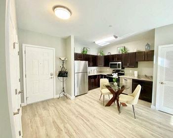 a kitchen and dining room with a table and chairs