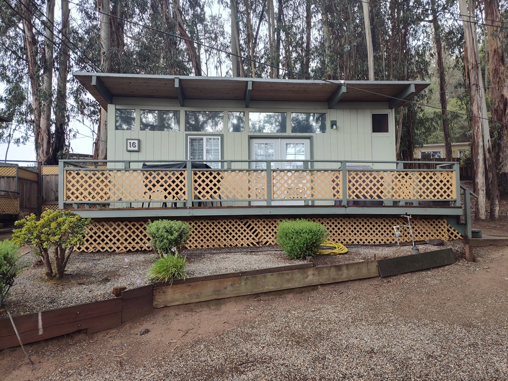 View of a cabin with a deck surrounded by trees at Salinas Sunset Apartments, California