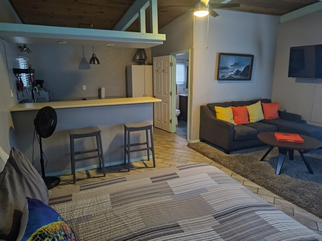 A living room with a couch and kitchen at Salinas Sunset Apartments, Salinas