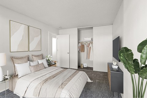 A bedroom with a large bed and a TV on the wall.