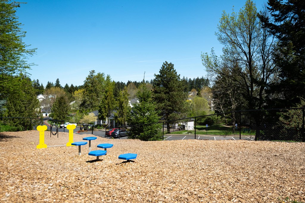a park with a playground and blue benches at Murrayhill Park, Oregon