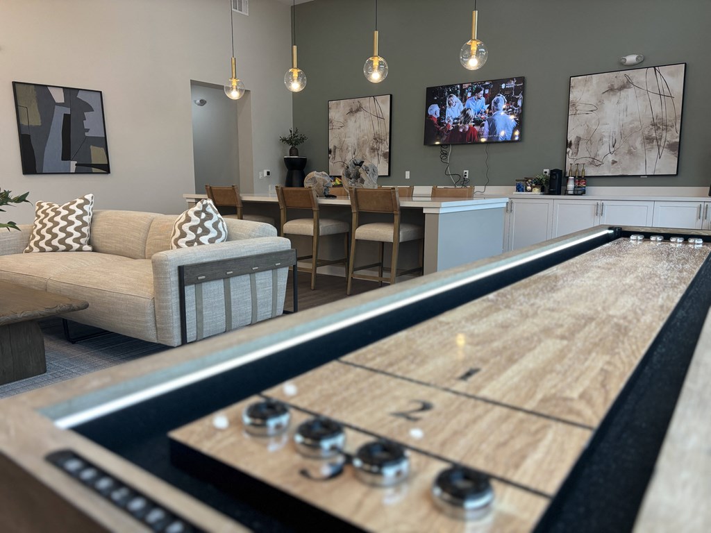 Clubhouse with shuffleboard table and a kitchen with a television