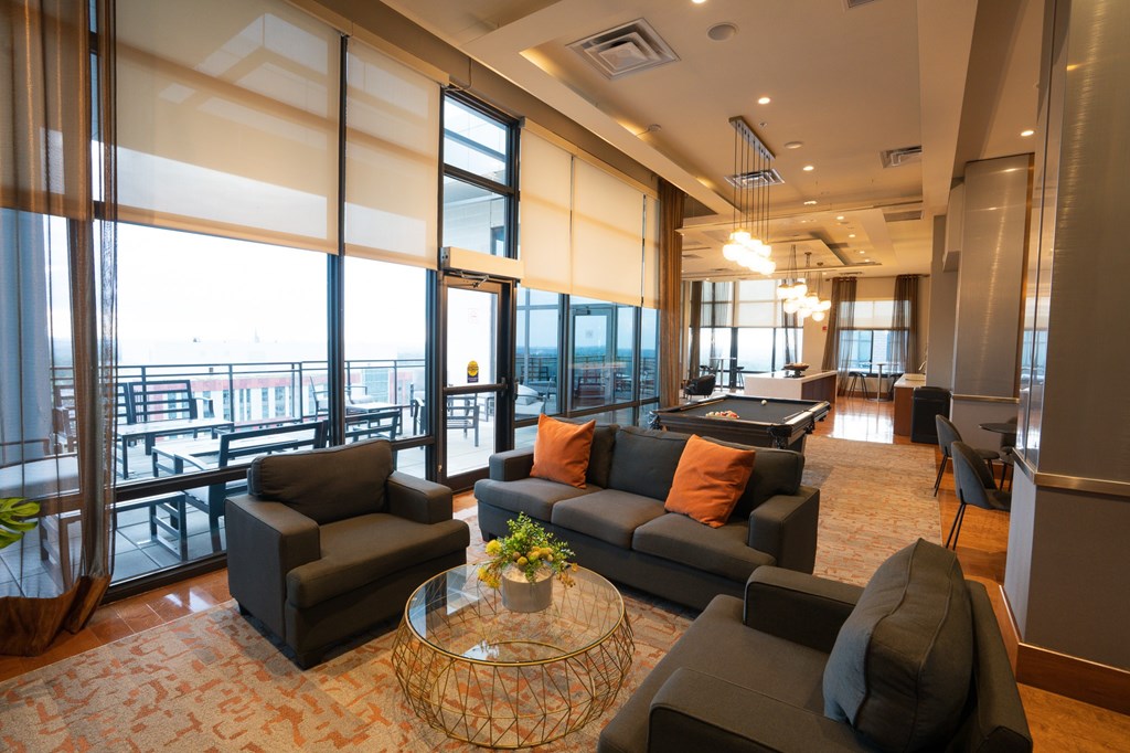 A living room with a glass table and a sofa.