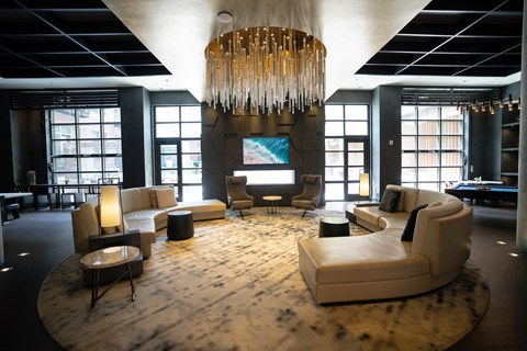 Large common area with sofas, chairs and windows