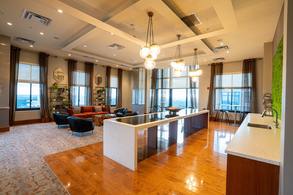 A large, well-lit room with a reception desk and a long table with chairs.