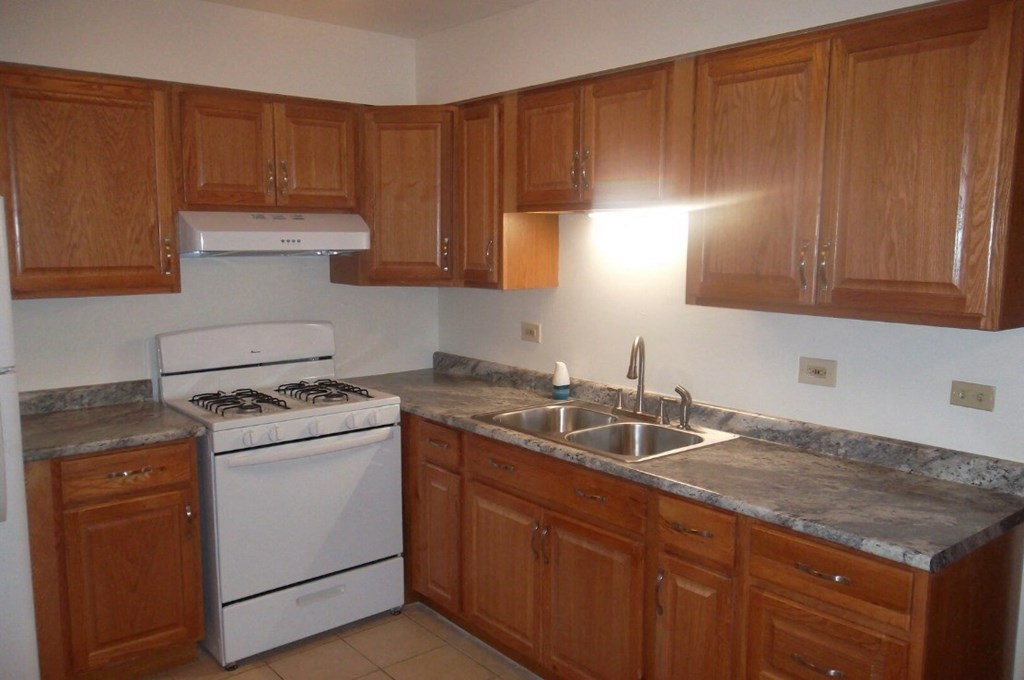 Kitchen with a white stove and wooden cabinets.at The Countryside, Countryside, IL 60525 ?