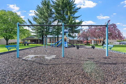 A playground with a swing set and a slide.