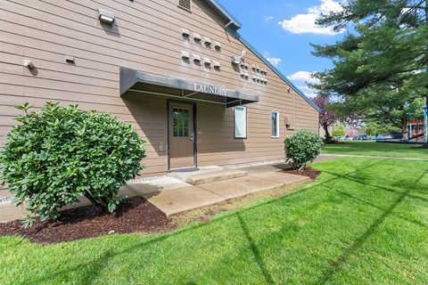 A building with a green lawn in front of it.