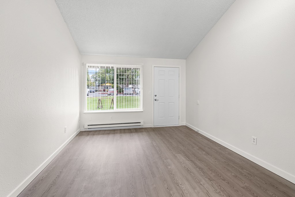 A room with a window and a door.