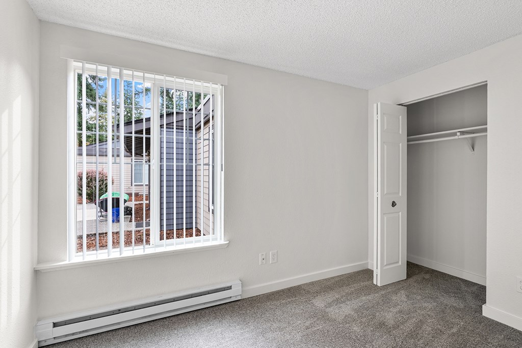 A room with a window and a closet