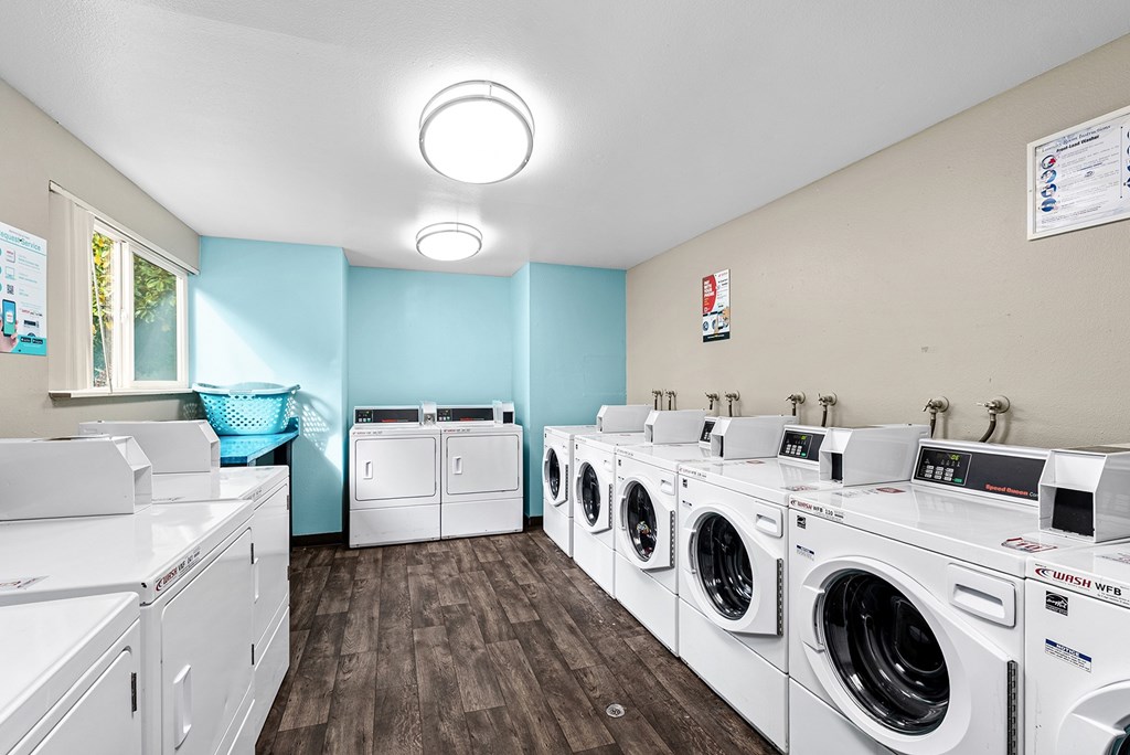 A row of washing machines in the onsite laundry facility