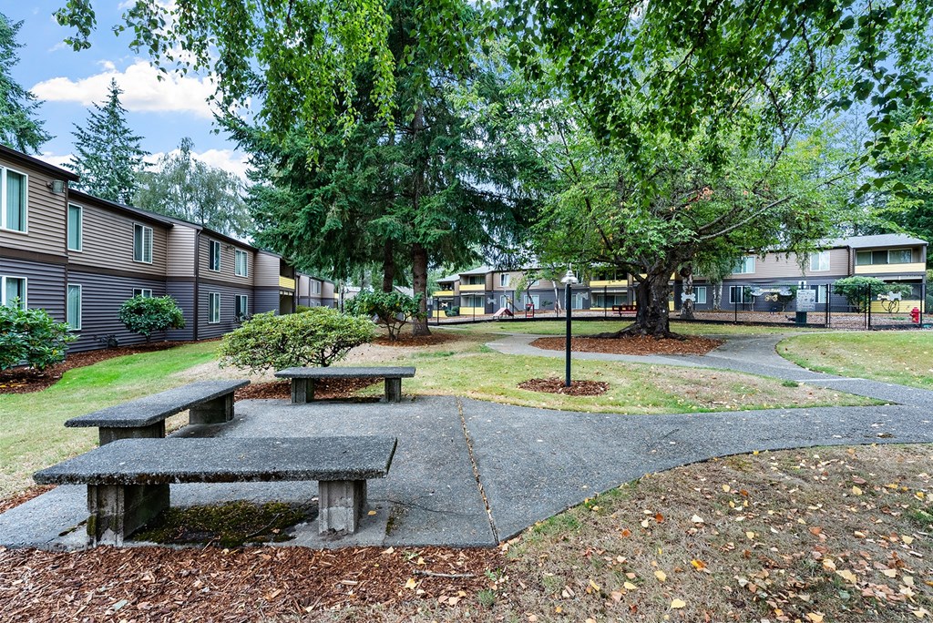 Courtyard with tables and apartment buildings in the background
