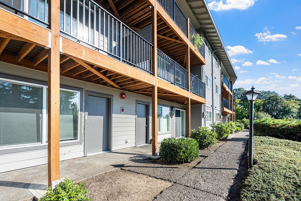 A sunny day at a modern apartment complex with a clear blue sky.