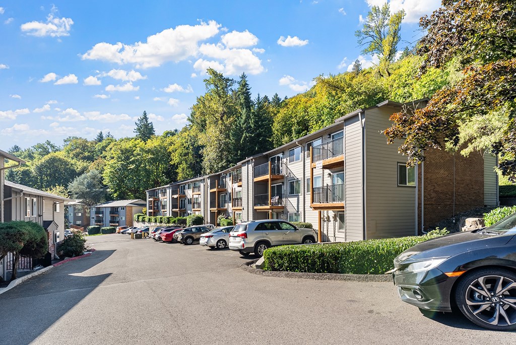 Apartment exteriors with a parking area and trees