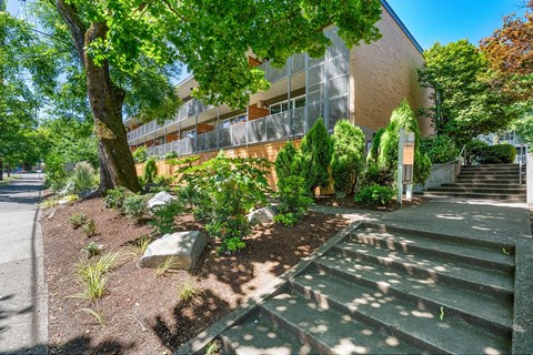 A building with a green lawn in front of it.