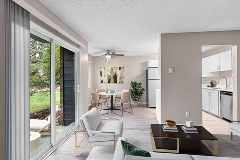 A modern living room with a sliding glass door leading to a garden.