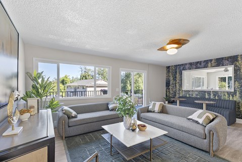 A living room with two grey couches and a coffee table.