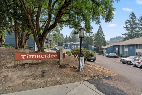 A Timberlee sign is in front of a tree.