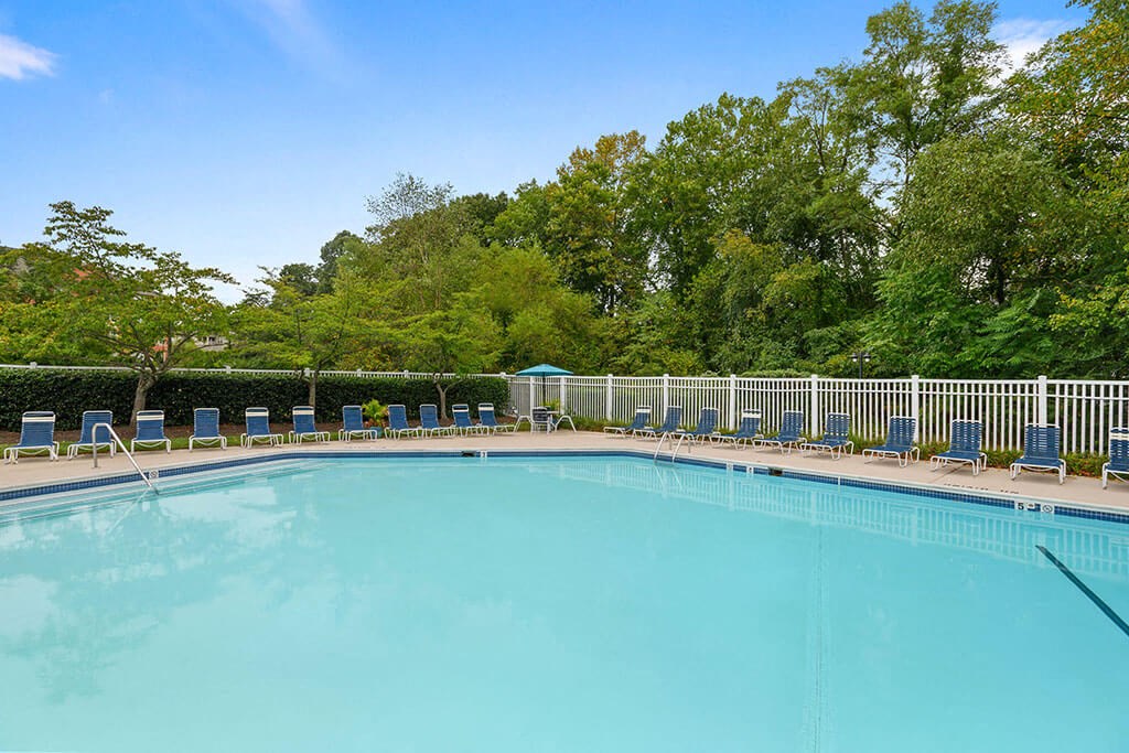 a swimming pool with chairs and trees in the background at ReNew Odenton, Odenton, MD, 21113