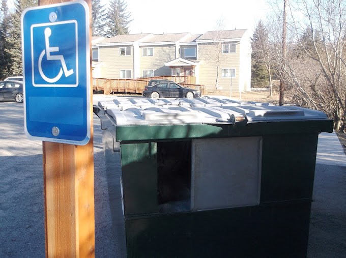 a picture of a handicapped sign on a street at Conifer Woods Apartments, Alaska, 99603