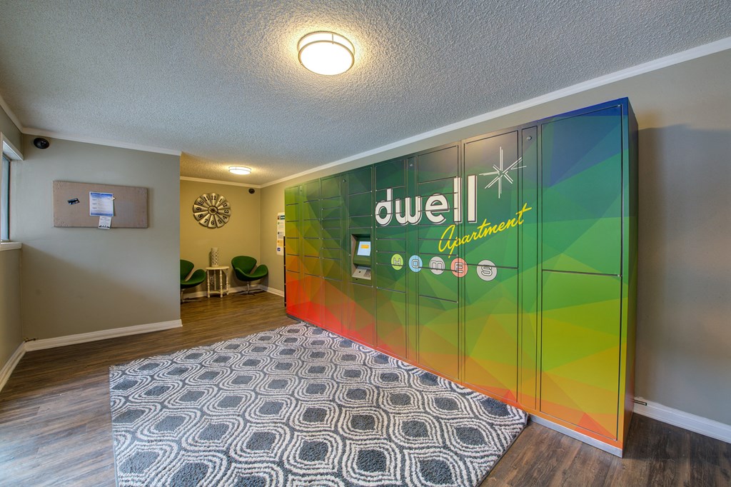 a room with a rug and a large sign on the wall at Dwell Apartment Homes, Riverside, CA