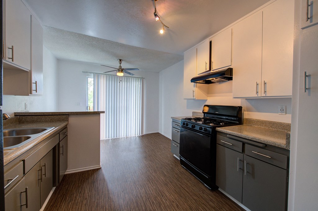 a kitchen with white cabinets and a black stove top oven