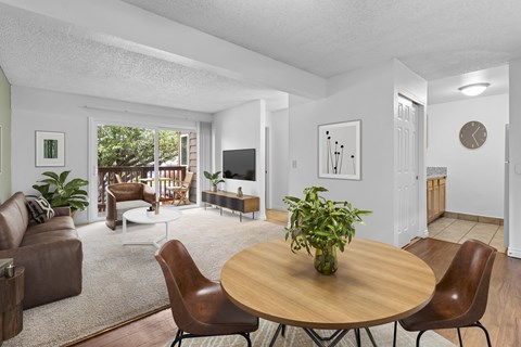 A living room with a brown table and chairs.
