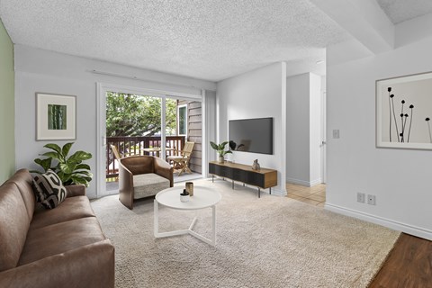 A living room with a brown couch and a white coffee table.