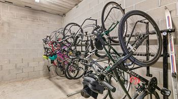 A bike rack full of bicycles in a garage.