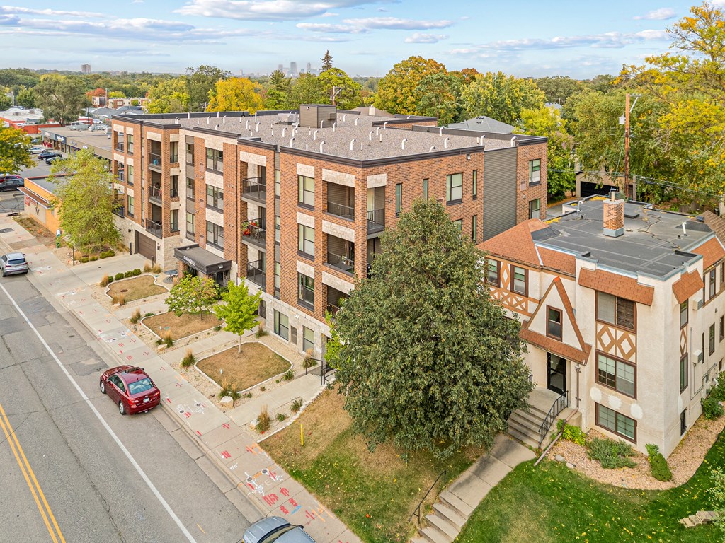 Exterior of apartment buildings near trees and a street