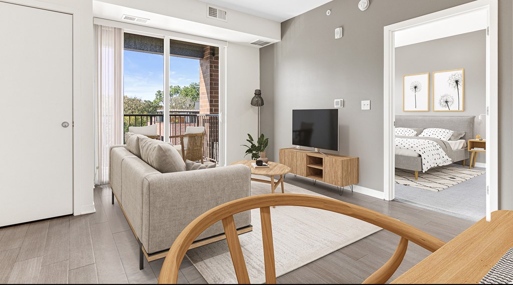 A living room with a grey couch and a television.