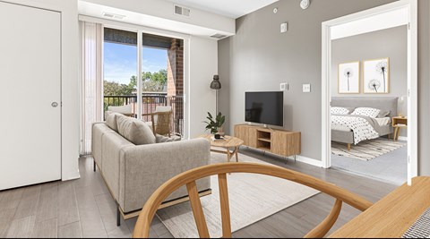 A living room with a grey couch and a television.