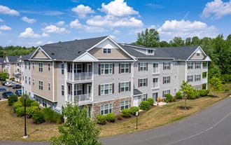 an aerial view of an apartment building with a road in front of it