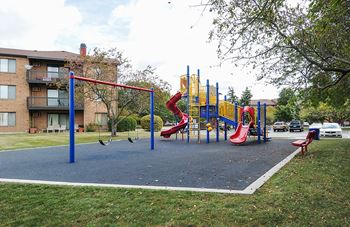 a playground with several slides in a park