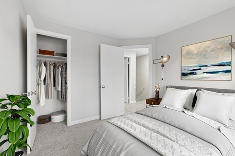 A bedroom with a large bed and a painting on the wall.