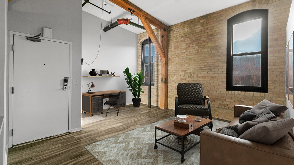A modern living room with a brick wall and a large window.
