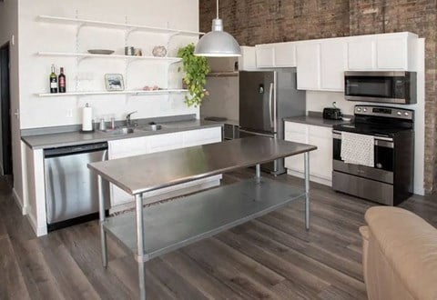 a modern kitchen with a stainless steel table