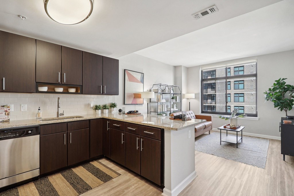 an open kitchen and living room with a large window