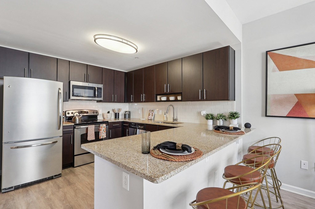 a kitchen with stainless steel appliances and a granite counter top