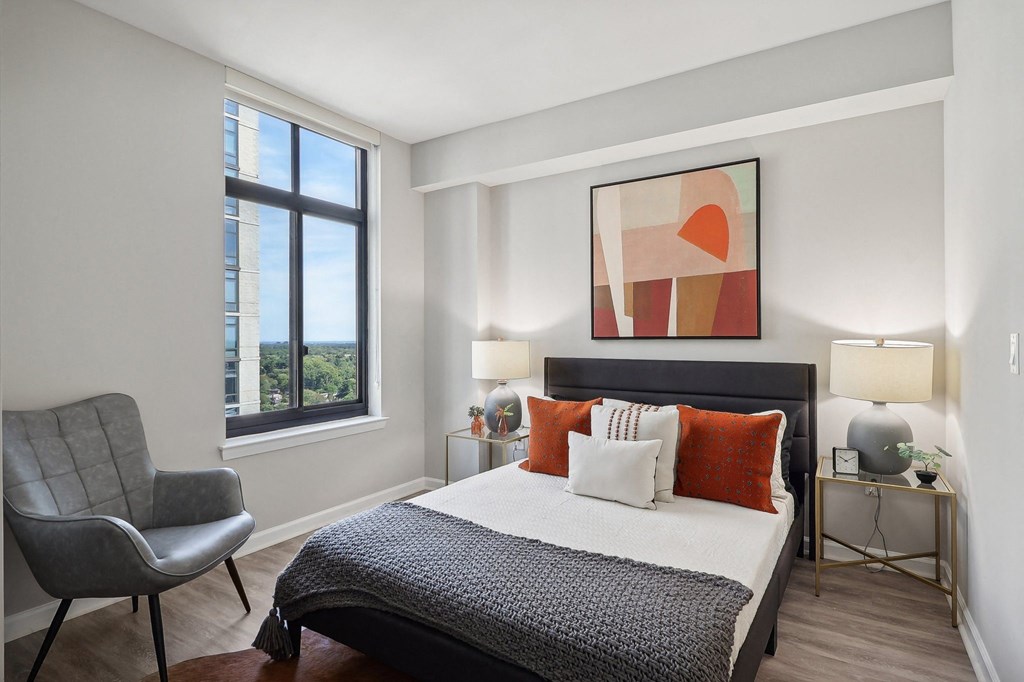 a bedroom with a bed and a large window