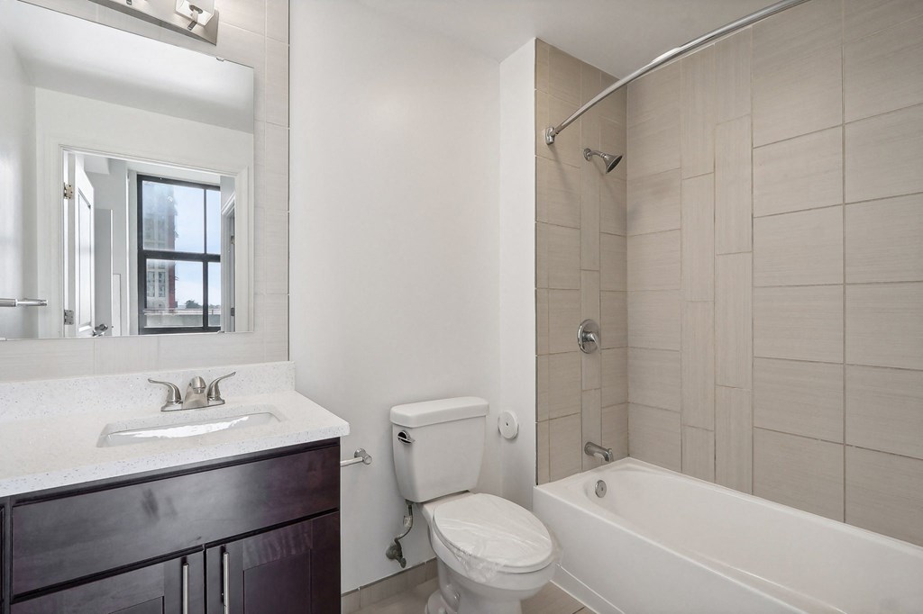 a bathroom with a toilet sink and tub and a shower