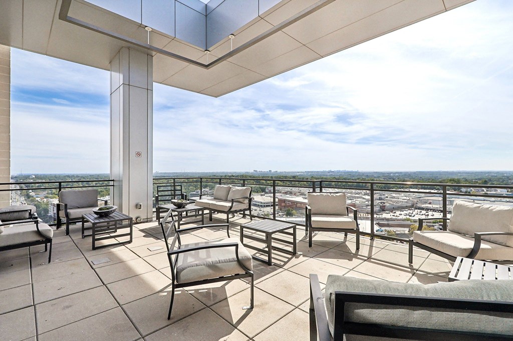 outdoor sitting area with patio furniture and a view of the city