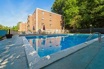 a swimming pool with a building in the background