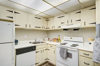 a kitchen with white appliances and white cabinets