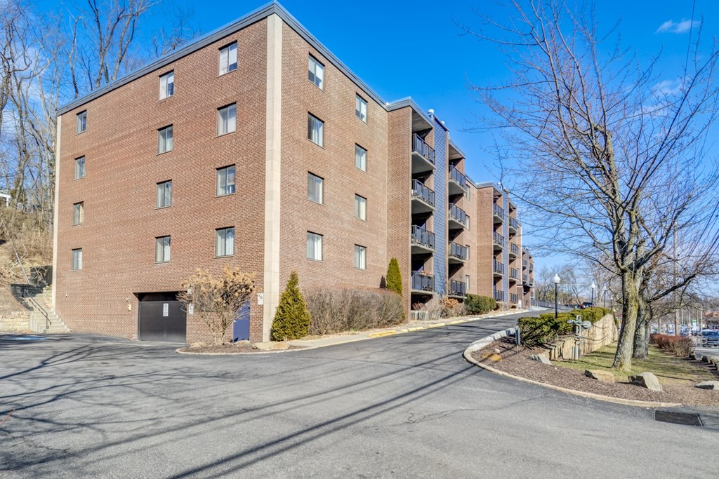 a large brick building with a street in front of it
