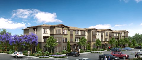 A row of townhouses with cars parked in front.