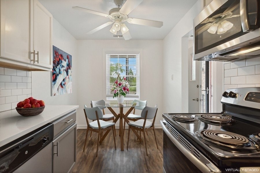 A modern kitchen with a dining table set for four.