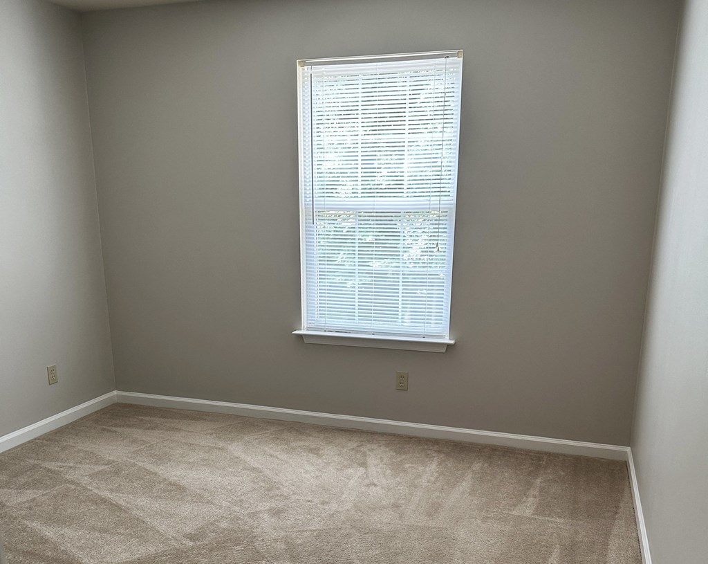 a bedroom with a large window and a carpeted floor at Woodgate, Virginia