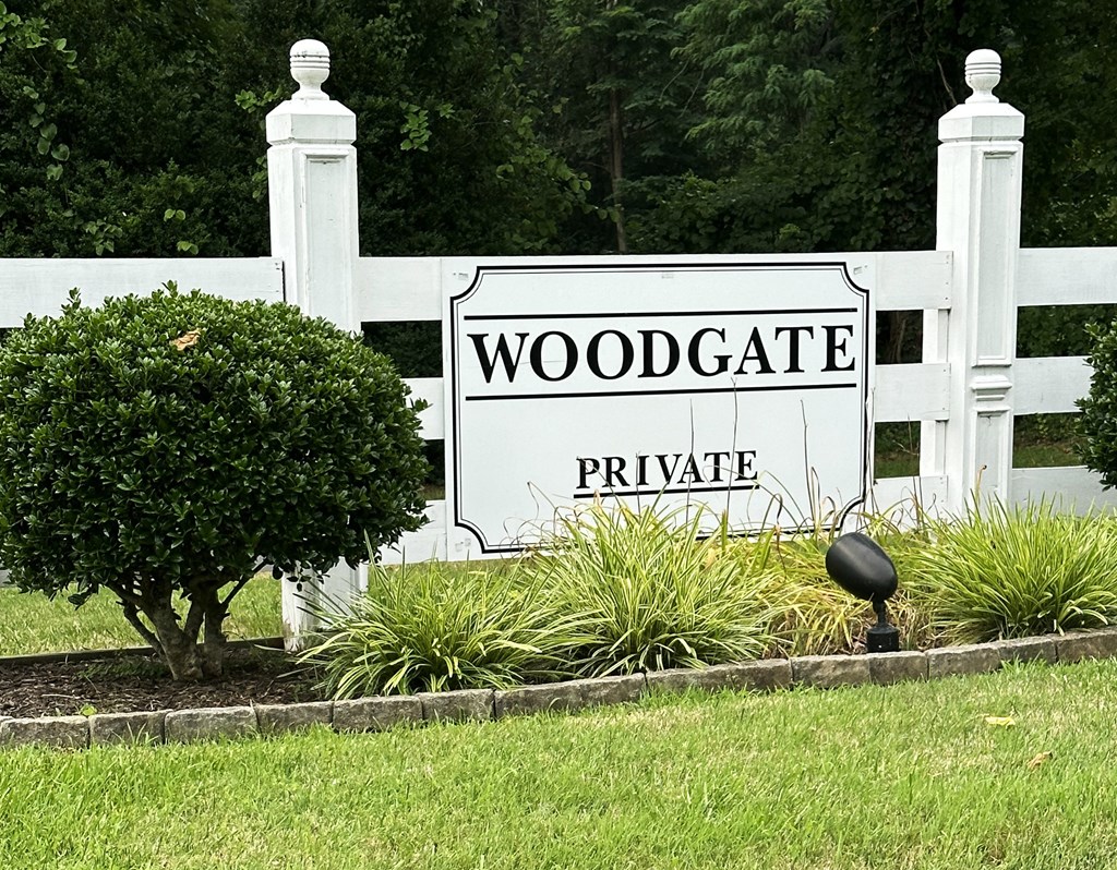 a white fence with a sign that reads woodgate private at Woodgate, Virginia