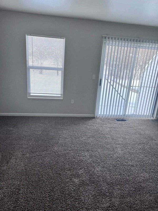 an empty room with a door and a window